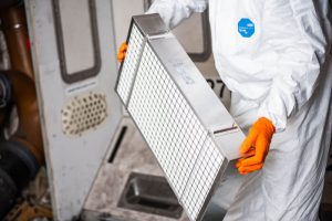 A worker holding a HEPA filter