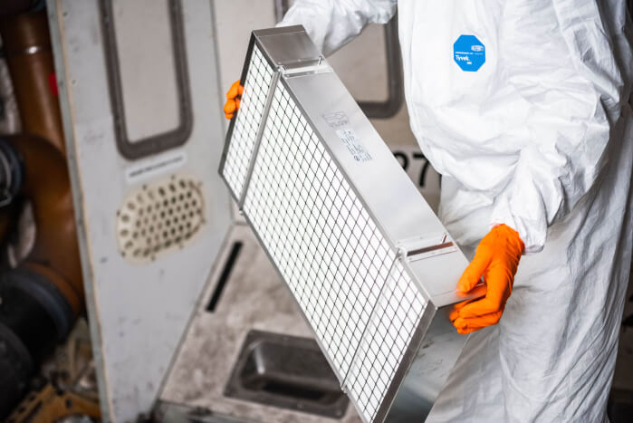 A worker holding a HEPA filter