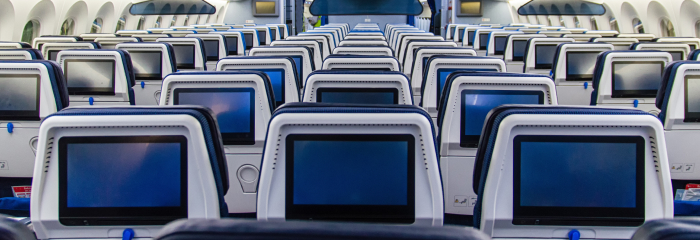 The back of plane seat with blank screens