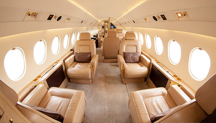 The inside of a Business Jet with six seats visible in cream colour