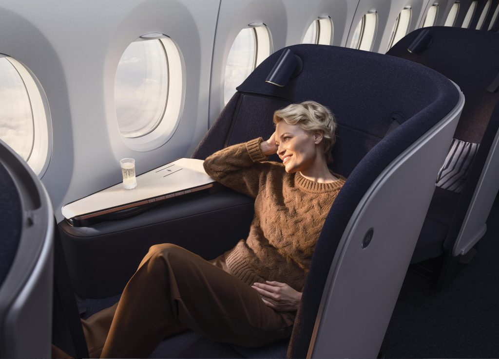 A person seating in a luxury seat in an airplane