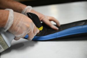 hand holding spray bottle cleaning leather