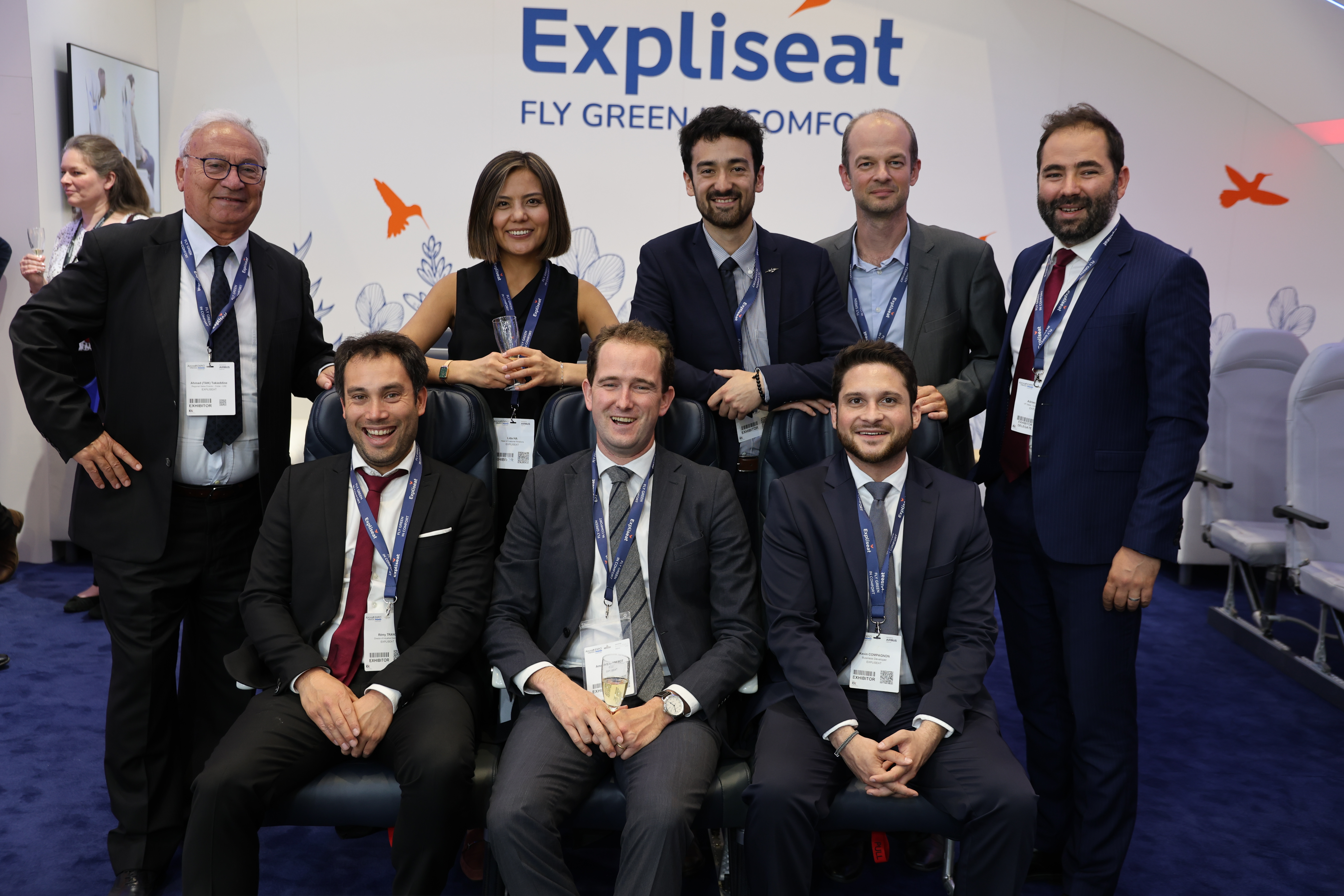 expliseat team seated and standing in suits