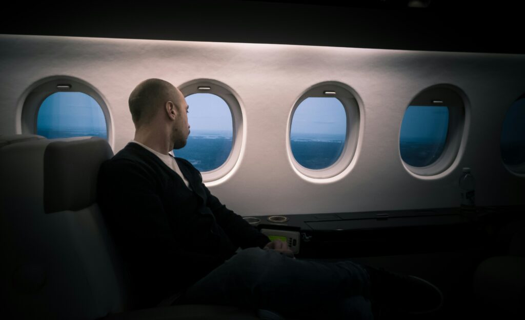 man on plane looking out window